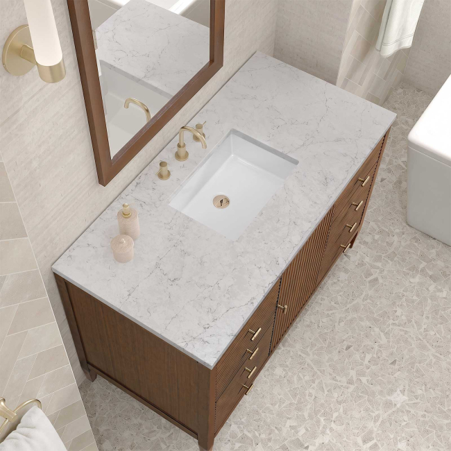 Includes Eternal Jasmine Pearl quartz vanity top and rectangular sink (may not be pictured on main image)

Included Components:

Covered under James Martin Vanities' 1 year limited warranty
Ash, poplar and walnut vanity cabinet with 1 door, 6 drawers and 1 shelf
Silestone quartz vanity top with 1 rectangular porcelain sink
Cabinet Features:

Constructed with a solid wood frame and plywood panels
One 120-volt UL rated electric outlet with USB ports and bamboo organizer included
Includes one soft-close door that opens to an interior shelf and three full-extension drawers that feature soft-close undermount glides
Toggle style door pulls
The drawer boxes feature English dovetail joinery, and an brushed aluminum laminate drawer liners for easy cleaning
Includes one removable bamboo drawer organizer
Cabinets are sealed with a premium finish for superior moisture and UV resistance
Vanity Top Features:

Vanity set includes a 3cm eased edge Eternal Jasmine Pearl quartz Silestone quartz top
Includes a white porcelain rectangular undermount sink that ships separately and mounting brackets for easy installation
Top is pre-drilled for 8" widespread faucet
Faucet not included
Quartz vanity tops are curated from a 95 percent blend of ground natural quartz with 5 percent polymer resin to create an ultra-durable and low maintenance surface
Quartz requires no sealing and resists staining and corrosion from liquids, including most household cleaning products
Center drain location provides optimal draining capability
Equipped with an overflow to help prevent water overflow and spillage from occurring
Cabinet Specifications:

Cabinet Width: 48" (from left to right)
Cabinet Height: 34-1/16" (from top to bottom)
Cabinet Depth: 23-1/2" (from front to back)
Number of Doors: 1
Number of Drawers: 6
Number of Shelves: 1
Vanity Top Specifications:

Vanity Top Width: 48" (left edge to right edge)
Vanity Top Depth: 23-1/2" (front edge to back edge)
Vanity Top Thickness: 3 cm (1-3/16")
Number of Basins: 1
Number of Faucet Holes: 3
Faucet Centers: 8" (distance between the installation holes for the faucet handles)